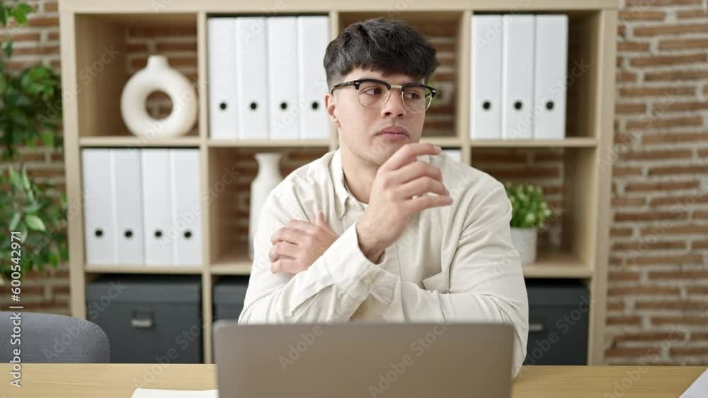 Young hispanic man business worker using laptop working with doubt expression at office Young hispanic man business worker using laptop working with doubt expression at office