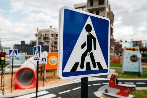 road signs at a public playground against the backdrop of luxury real estate construction