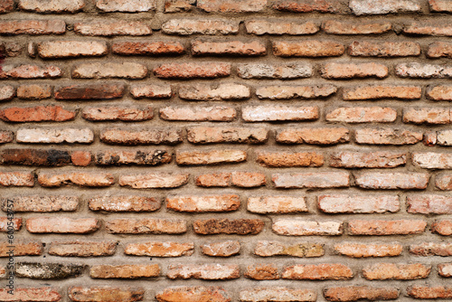 Old brick wall, abstract brown grunge background. Fragment of a brick wall of an old building in the old city of Tbilisi 