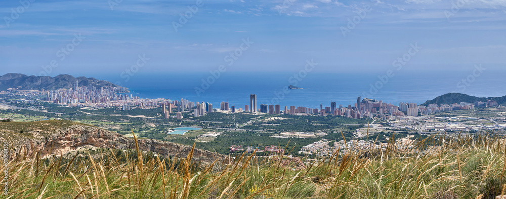 Benidorm city since of the mountains and sea on the background. Mediterranean coast landscape. Located in the valencian community, Alicante, Spain