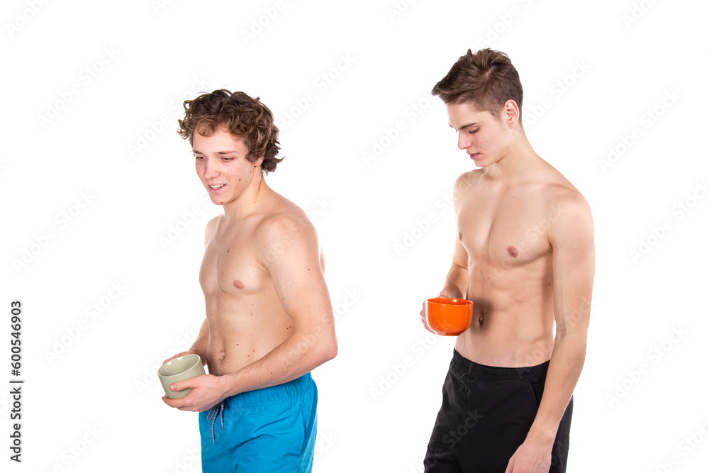 Two young attractive guys are drinking coffee. White background. Two young attractive guys are drinking coffee. White background.