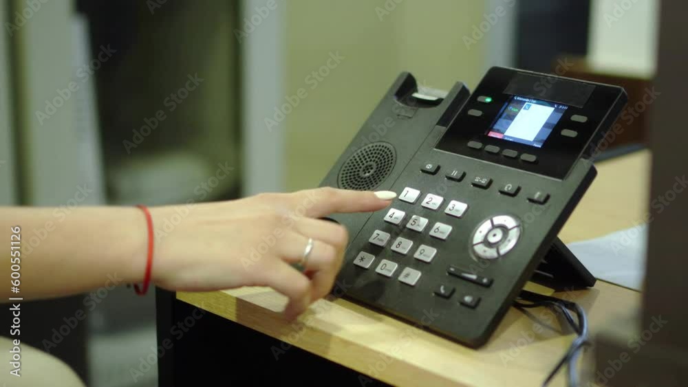 woman dialing phone number on landline phone woman dialing phone number on landline phone