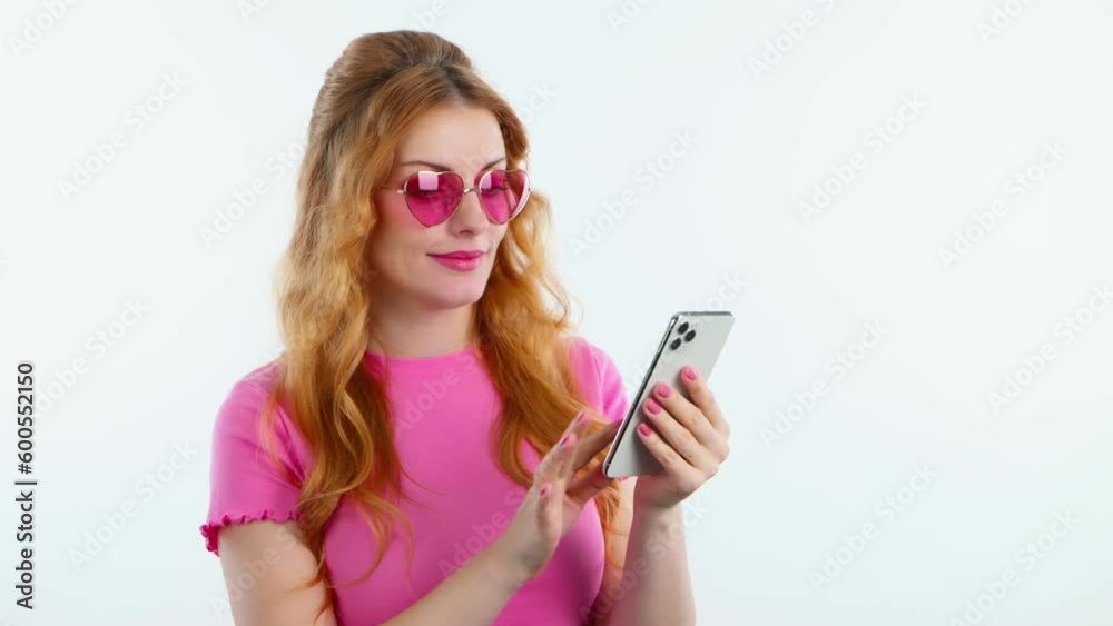 Woman talking on mobile cell phone, say Yes and approving on white studio background. Excited happy female redhead lady with smartphone for good news or victory and success
