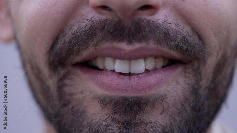 Close up of bearded man mouth becoming serious. Change of emotion and expression from Middle Eastern male person Close up of bearded man mouth becoming serious. Change of emotion and expression from Middle Eastern male person