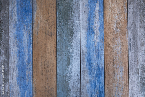 wooden boards with blue and beige paint and cracks. vertical lines. rough surface texture