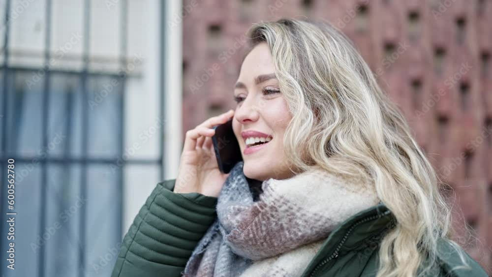 Young blonde woman smiling confident talking on the smartphone at street Young blonde woman smiling confident talking on the smartphone at street