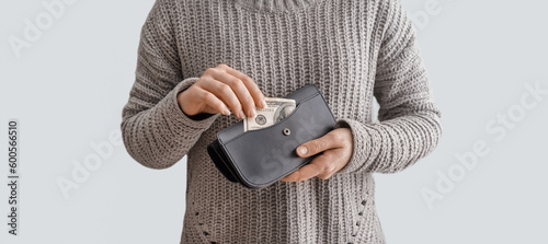 Woman holding wallet with m...