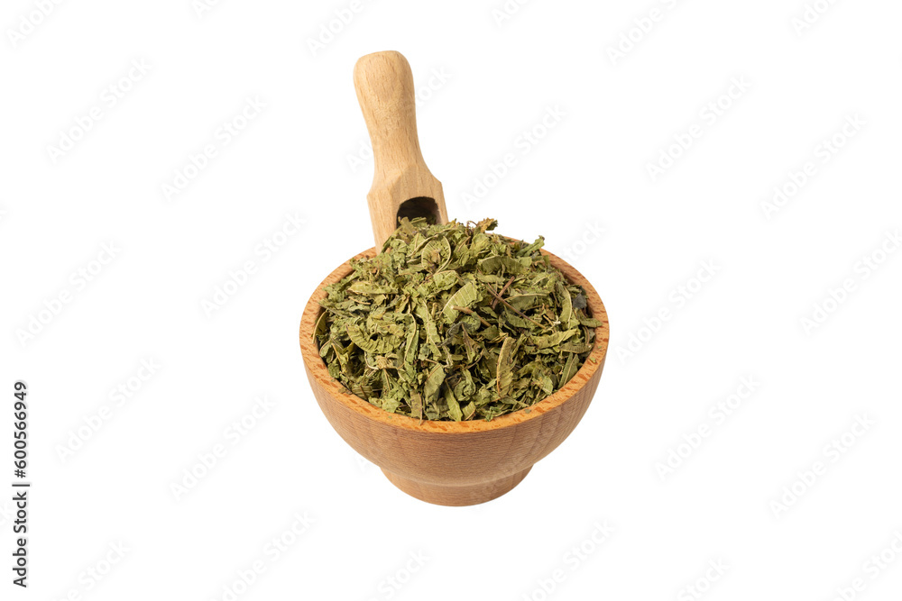 Dried leaves o Lemon verbena in latin Aloysia citrodora in wooden bowl and scoop isolated on white background. Medicinal herb. 