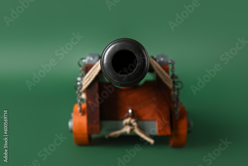Toy model of cannon on green background, closeup