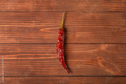 Dry hot chili pepper on brown wooden background