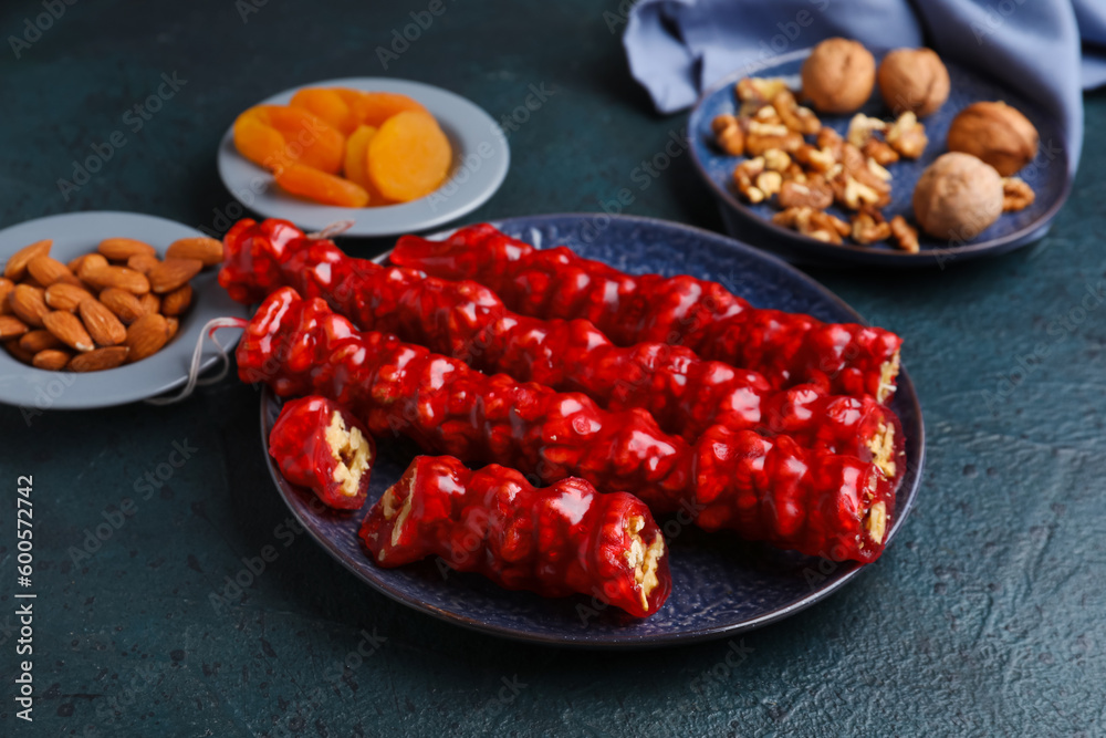 Plate with tasty churchkhela on dark background Plate with tasty churchkhela on dark background