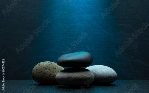 zen stones for podium stand pedestal platform background.grey and black oval stones on dark gray background for product presentation,background