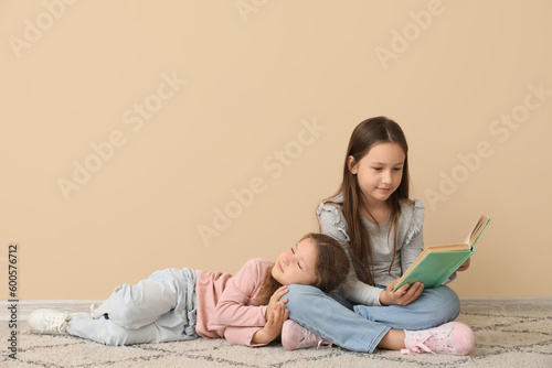 Little girls reading book n...