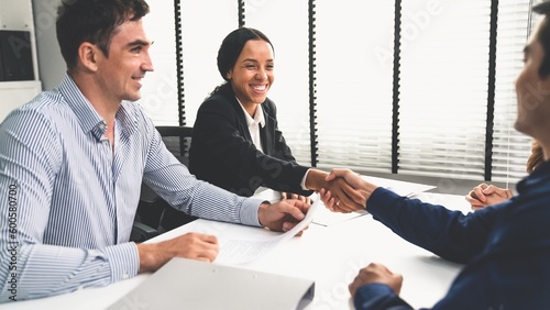 Commercial contract signed by competent people of various ethnicities and shake hands. Trade agreements, two-party business transactions. photo