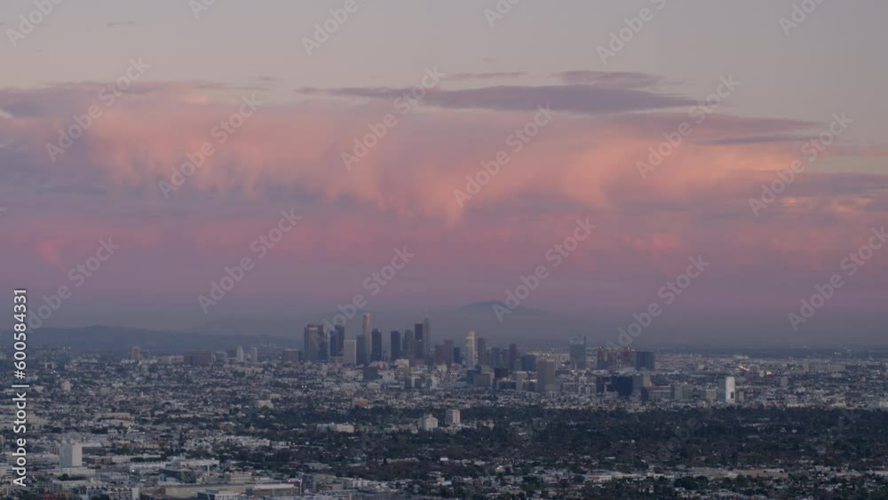 Aerial Panning Shot Of Cityscape And Mountains Against Cloudy Sky At Dusk, Drone Flying Over Neighborhood - Los Angeles, California Aerial Panning Shot Of Cityscape And Mountains Against Cloudy Sky At Dusk, Drone Flying Over Neighborhood - Los Angeles, California