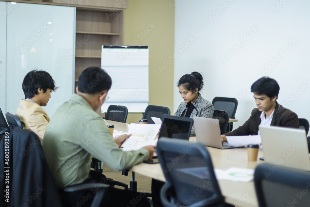 Business people working on laptop in meeting conference room at the office Business people working on laptop in meeting conference room at the office