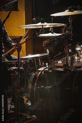 Photography Close-up of drummer drumsticks with a drum set.