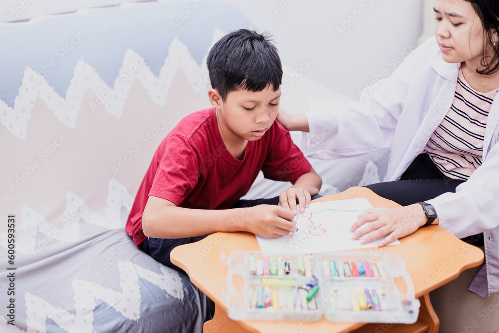 Autism awareness concept. Autism schoolboy during therapy at home with ...