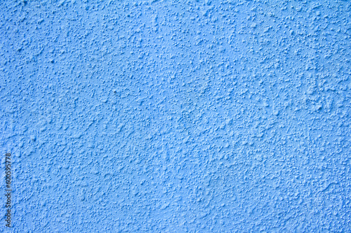 Blue painted plaster rough wall. Grunge abstract pastel trextured background for design.