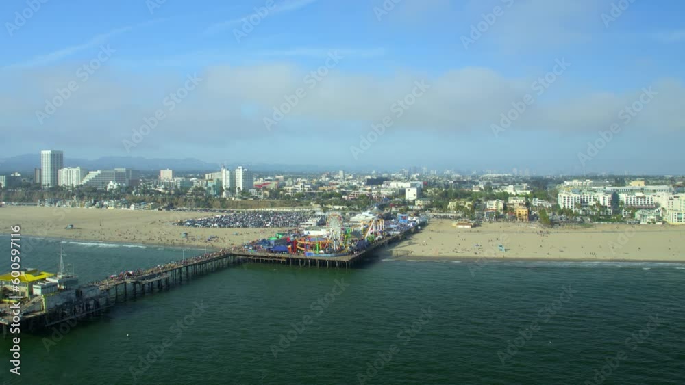 Aerial Shot Of Popular Santa Monica Pier At Beach, Drone Descending Forward Towards People - Los Angeles, California Aerial Shot Of Popular Santa Monica Pier At Beach, Drone Descending Forward Towards People - Los Angeles, California
