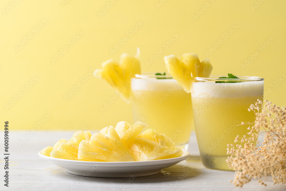 Pineapple smoothie in glass with sliced pineapple fruit, Tropical summer drink Pineapple smoothie in glass with sliced pineapple fruit, Tropical summer drink