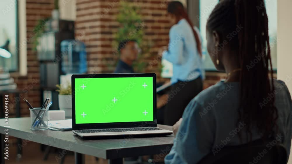 Office worker using greenscreen display, reading business data reports on isolated copyspace screen. Woman analyst working with chroma key blank mockup template on laptop, coworking space. Office worker using greenscreen display, reading business data reports on isolated copyspace screen. Woman analyst working with chroma key blank mockup template on laptop, coworking space.