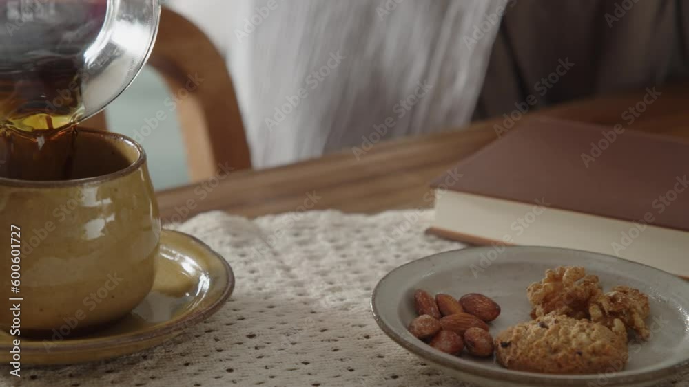 Pouirng hot coffee into a cup 02