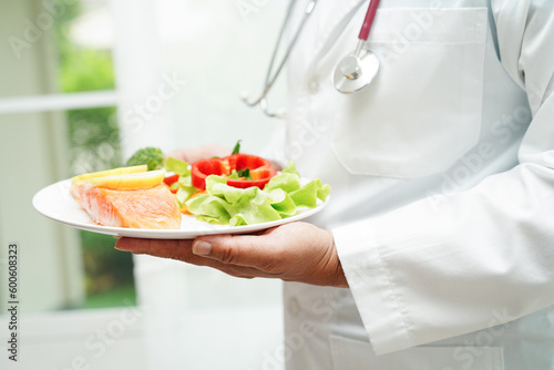 Asian Nutritionist holding healthy food for patient in hospital  nutrition and vitamin.