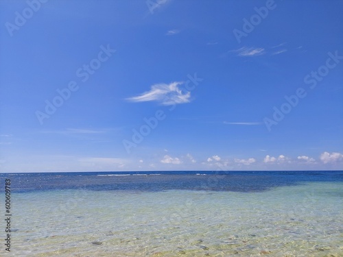 Shallow coast waters with blue sky background