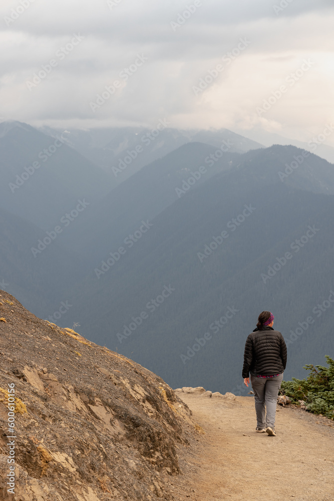 Young caucasian woman hikes at Hurricane Ridge in Olympic National Park in Washington State.
