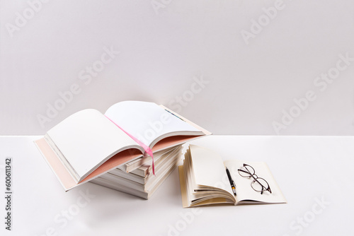 Stack of books with glasses on white background. Back to school concept.