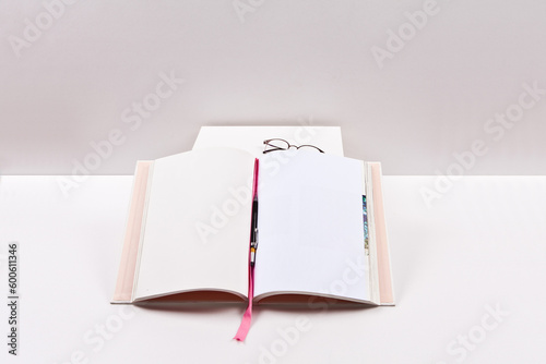 Open book with glasses on white background. Back to school concept.