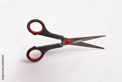 Black and red scissors isolated on white background, clipping path included.