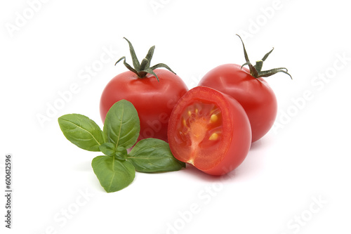Cherry tomatoes with basil leaves isolated on white