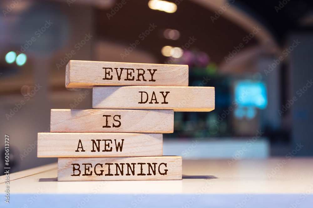 Wooden blocks with words 'Every day is a new beginning'. Inspirational motivational quote