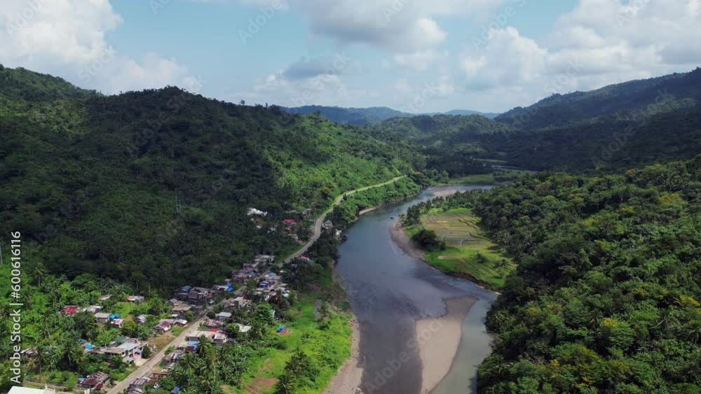 Residential Town Houses Along The River In The Foothill Of Verdant Mountain In The Philippines. - aerial Residential Town Houses Along The River In The Foothill Of Verdant Mountain In The Philippines. - aerial