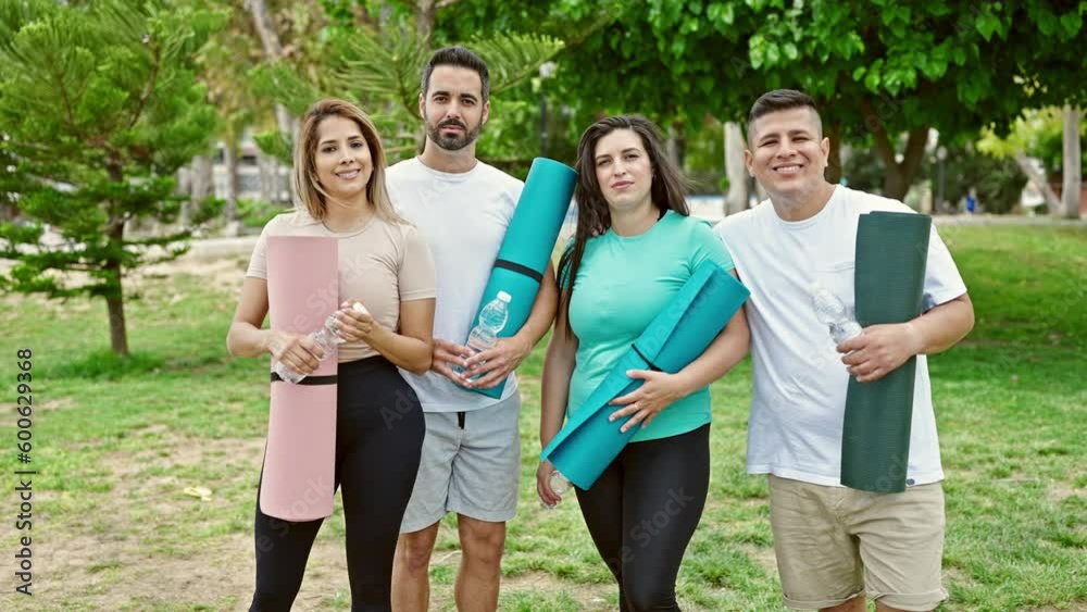 Group of people smiling confident holding yoga mat at park Group of people smiling confident holding yoga mat at park