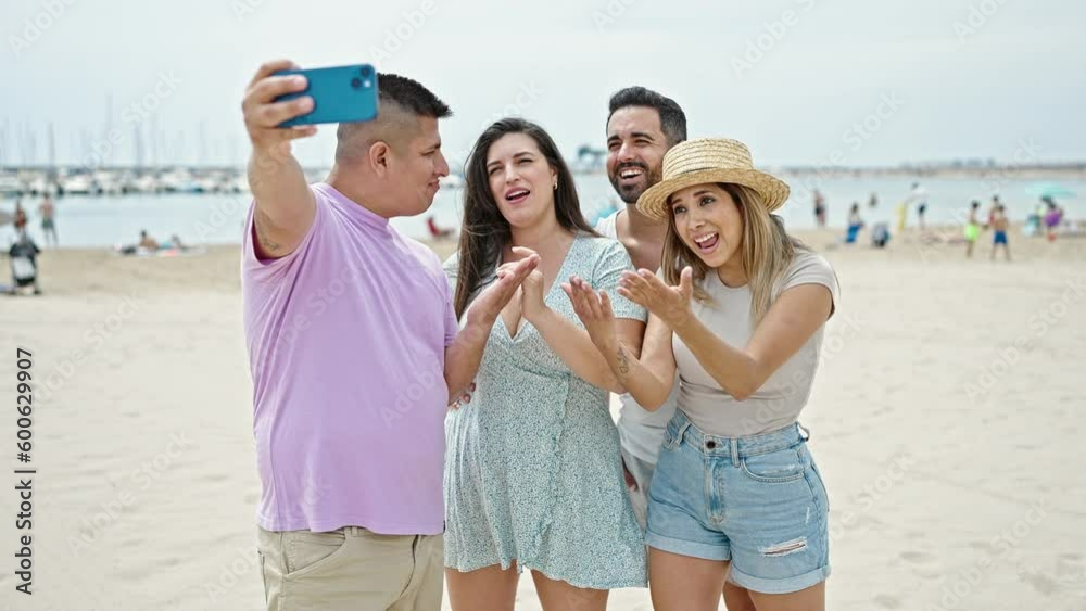 Group of people having video call smiling at beach Group of people having video call smiling at beach