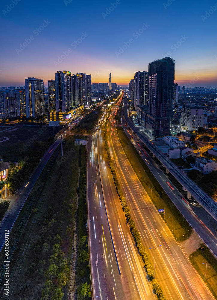 Fototapeta premium Sunset at overpass bridges in Cat Lai juntion, Ho Chi Minh city, Vietnam. Photos taken in April 2023.