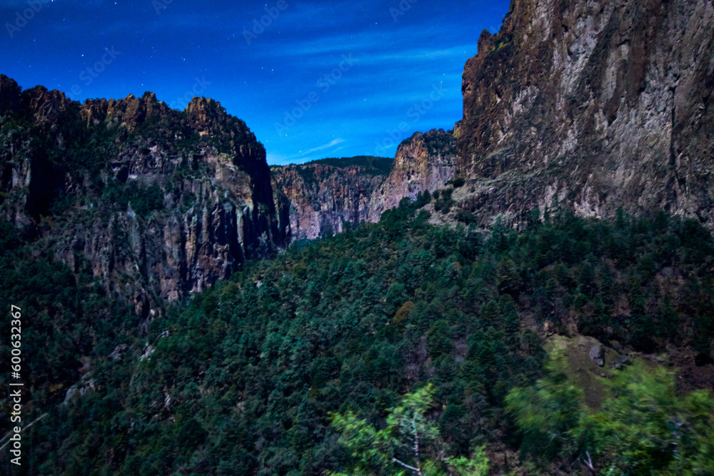 valley at night with moonlight, forest and big walls of stone in  basaseachi chihuahua 