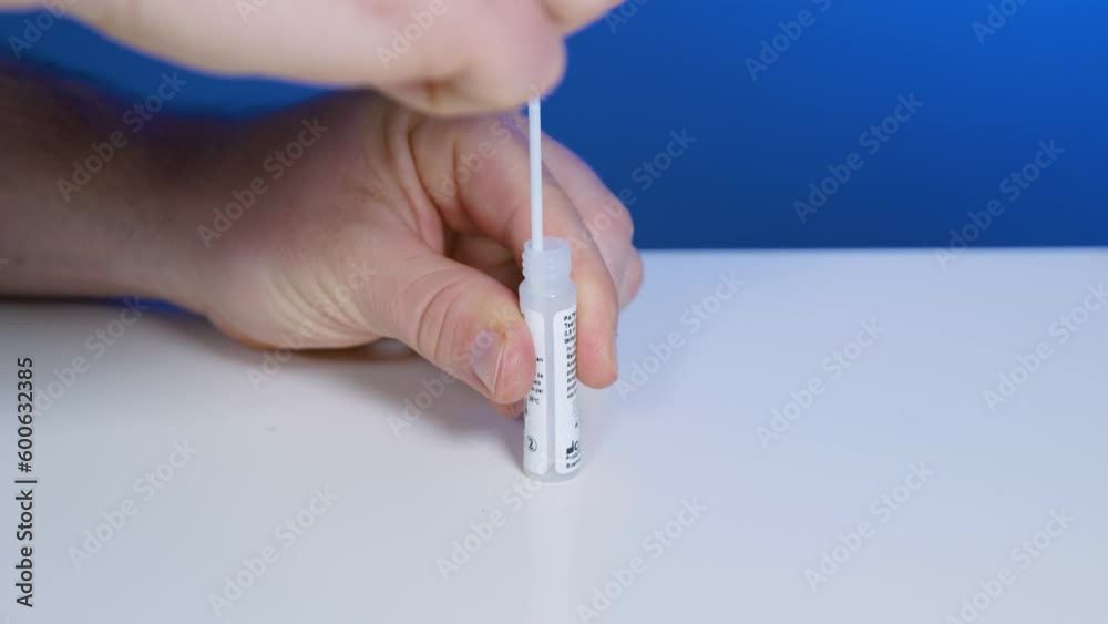 Squeeze dropper bottle with solution and take out swab sample for home-testing Squeeze dropper bottle with solution and take out swab sample for home-testing