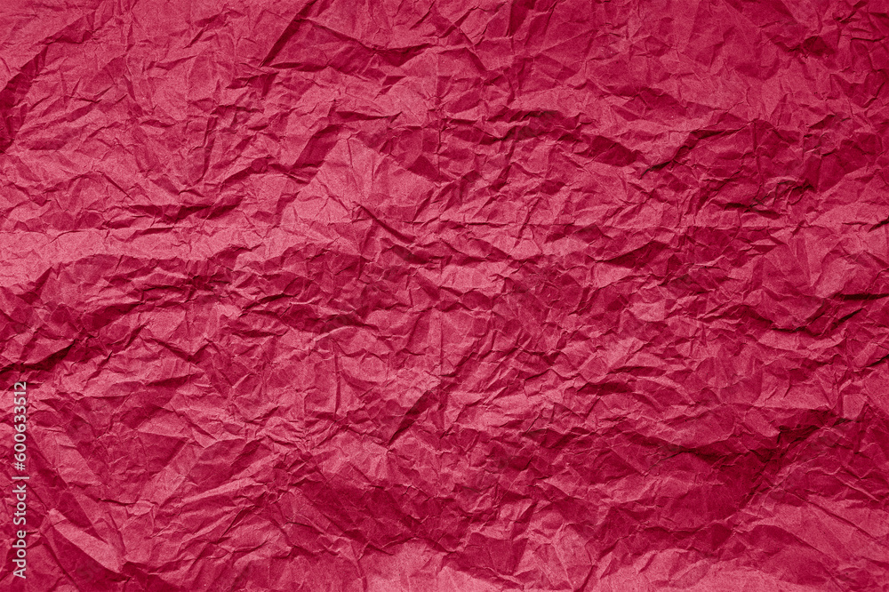 Natural abstract textured background of wrinkled paper of viva magenta color of the year 2023.