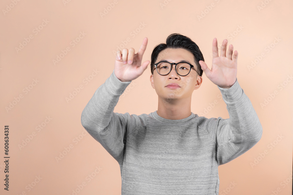 Front view of a asian man with his hands palms in front of him