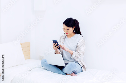 Asian woman enjoying the work she does in the happy bedroom