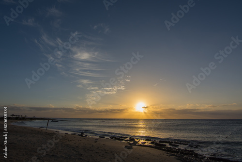 warm sunrise with soft cirrus clouds at the blue sky on the beach in egypt