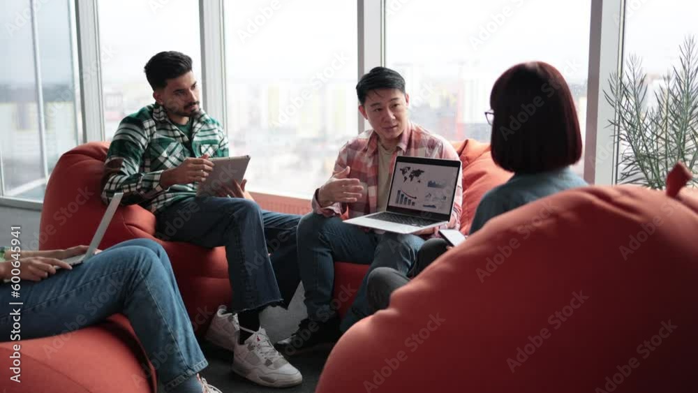 Close up of asian male explaining graphs and charts on digital screen while multiethnic workers enjoying presentation. Happy analytics professionals managing information in visual form in office. Close up of asian male explaining graphs and charts on digital screen while multiethnic workers enjoying presentation. Happy analytics professionals managing information in visual form in office.