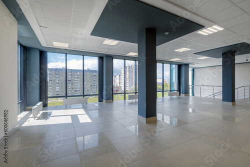 empty modern hall room with columns, doors and panoramic windows.