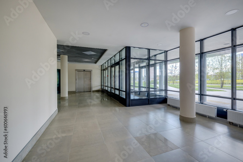 empty modern hall room with columns, doors and panoramic windows.