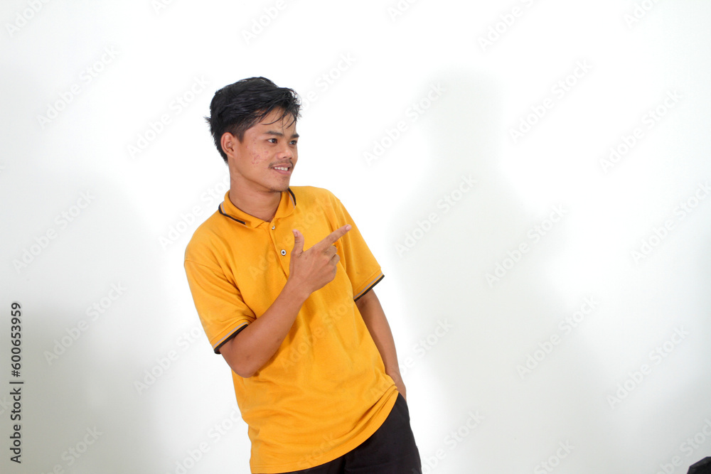 Expressive Indonesian man smiling over isolated white background showing one hand towards empty space
Expressive Indonesian man smiling over isolated white background showing one hand towards empty space