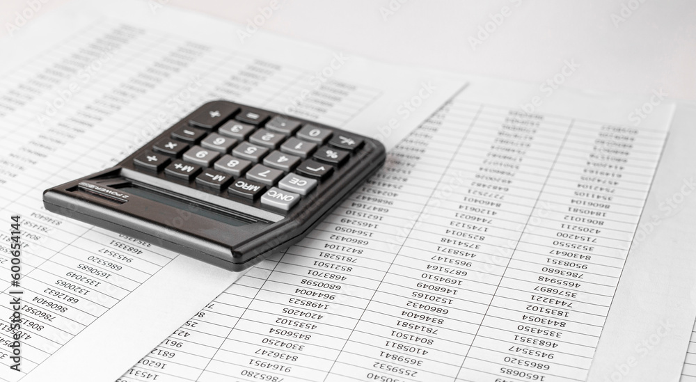 Calculator on financial statement and balance sheeet on desk of auditor. Concept of accounting and audit business. Calculator on financial statement and balance sheeet on desk of auditor. Concept of accounting and audit business.